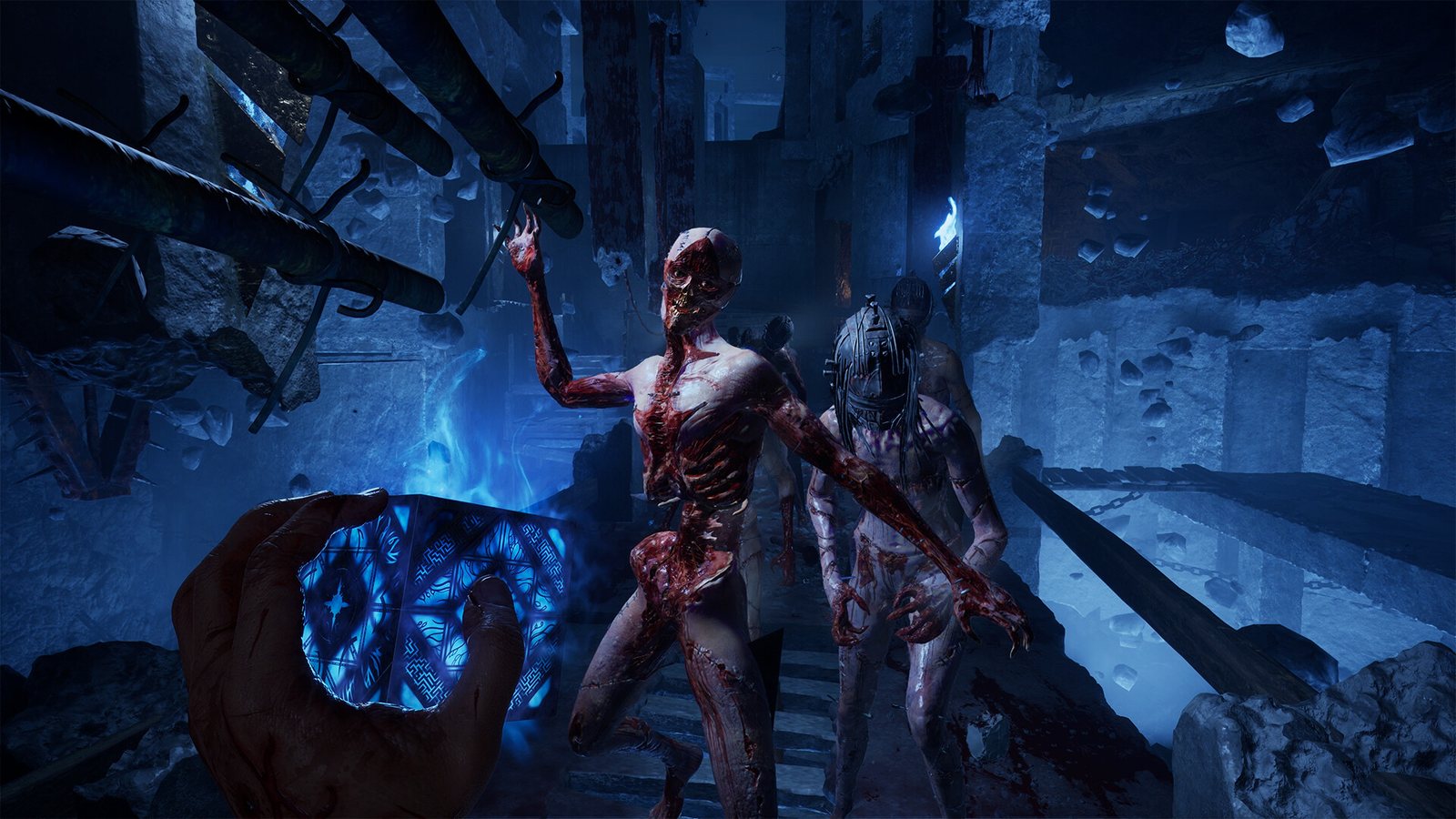 Bloodied figures advancing through a ruined chain-hung chamber